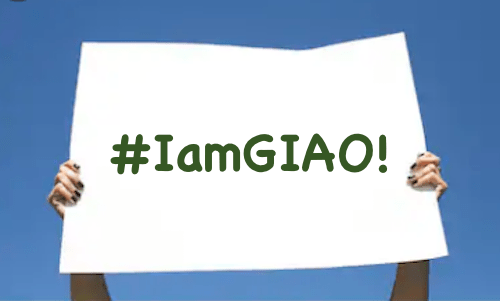two hands holding up a sign that reads #IamGIAO!